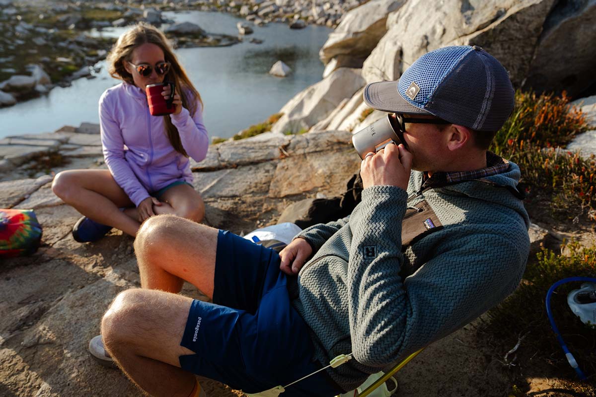 Drinking coffee at camp wearing fleece jackets